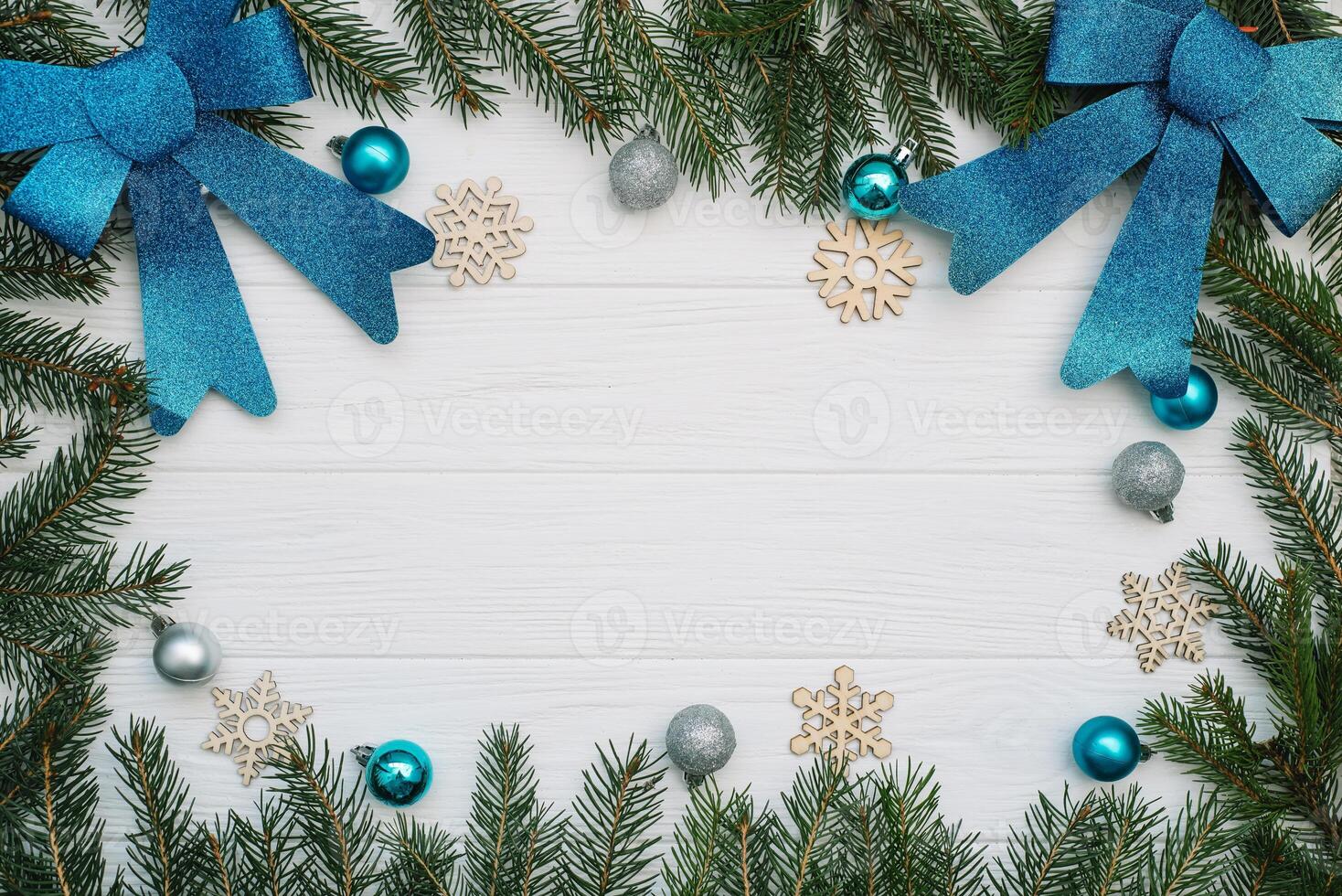 Christmas fir tree with decoration and glitters on wooden background. Christmas background on the white wooden desk photo