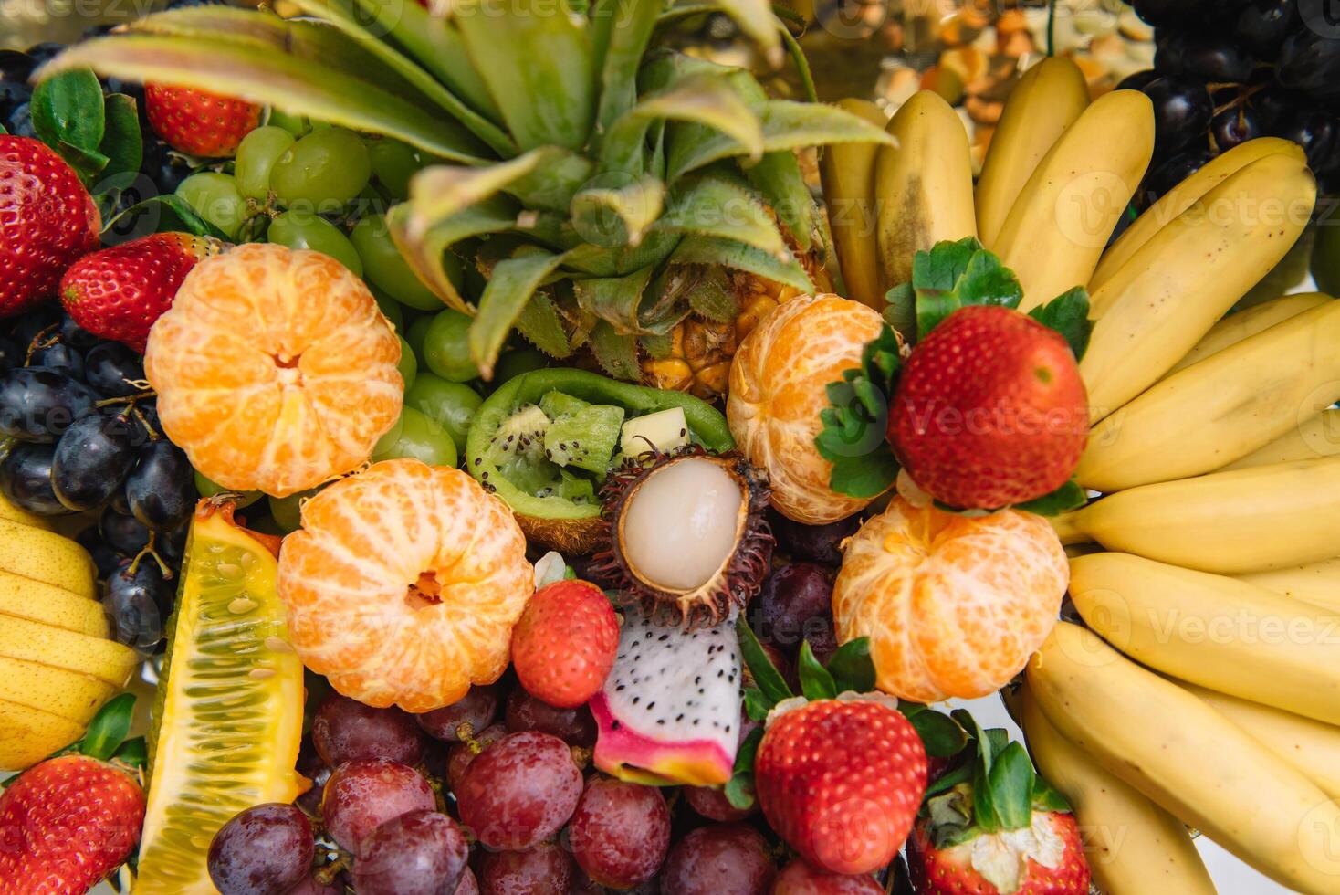 Fresh organic fruits background. Healthy eating concept. Fresh, exotic, organic fruits, light snacks in a plate on a buffet table photo