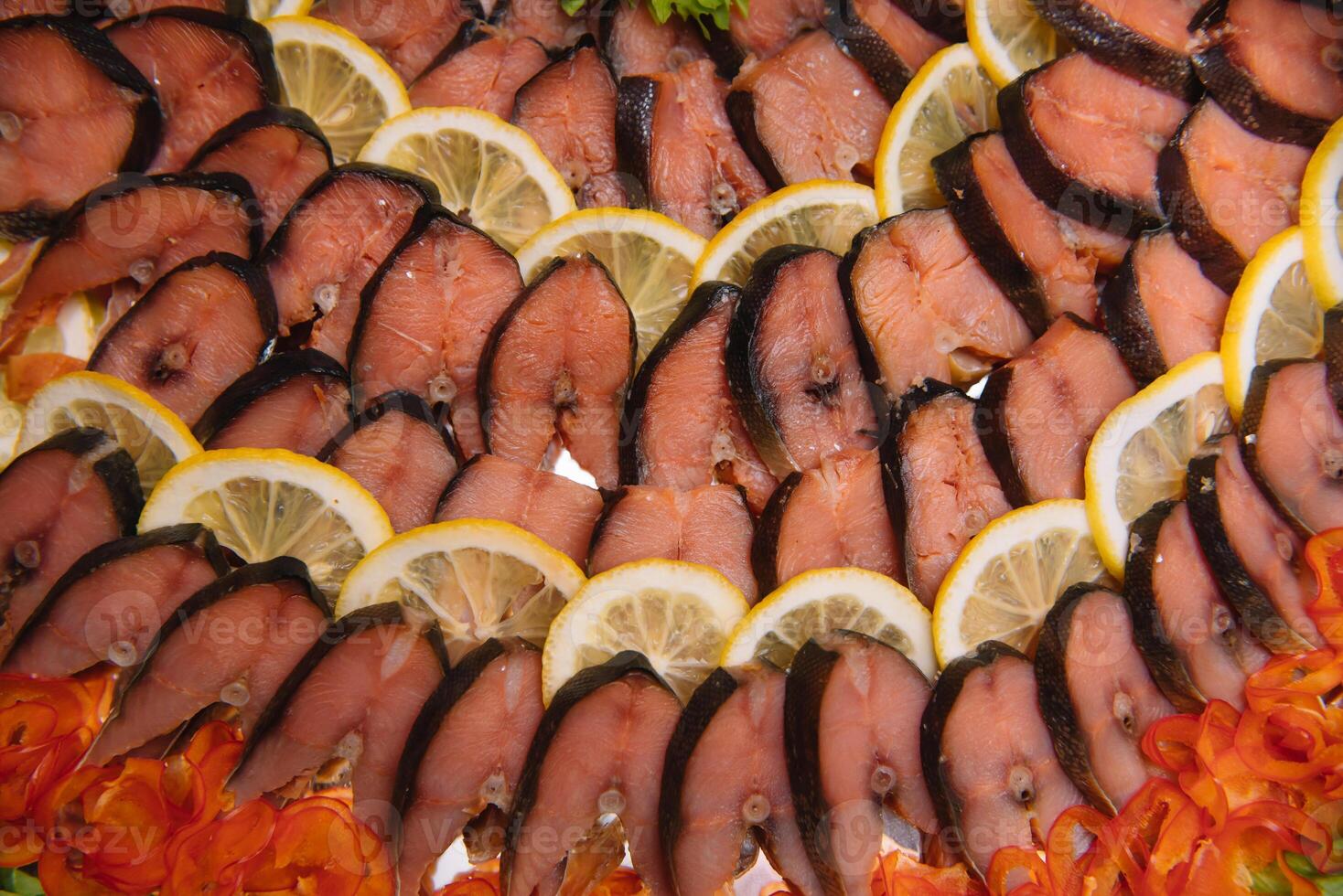 Elegant Restaurant Plate with Fish Delicacies Top View. Smoked Butter Fish with Lemon. smoked fish with lemon buffet. photo