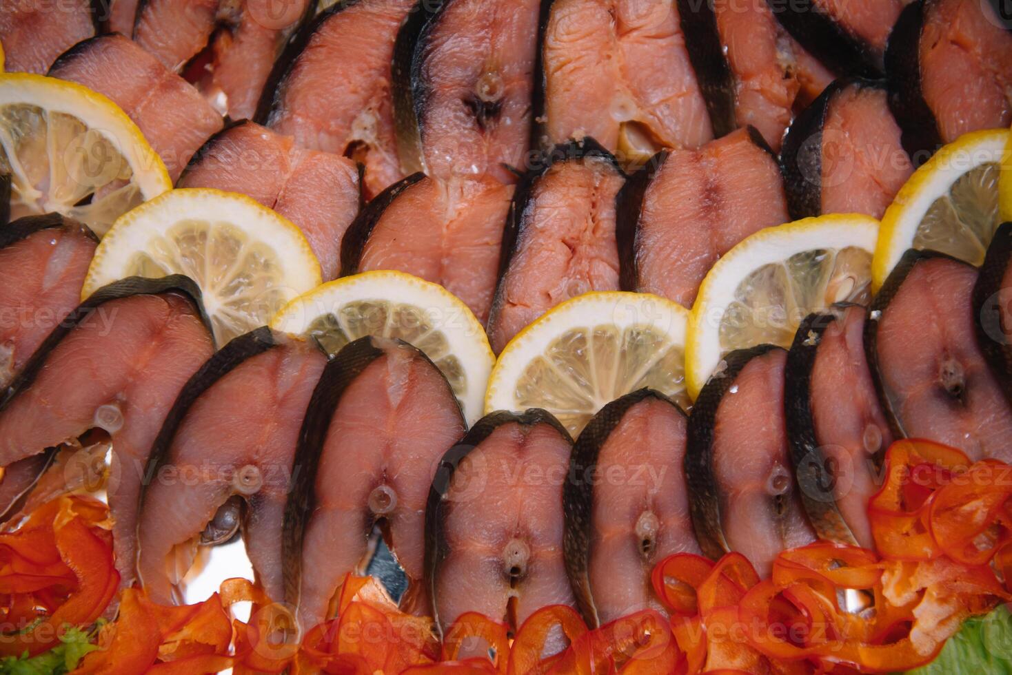 Elegant Restaurant Plate with Fish Delicacies Top View. Smoked Butter Fish with Lemon. smoked fish with lemon buffet. photo