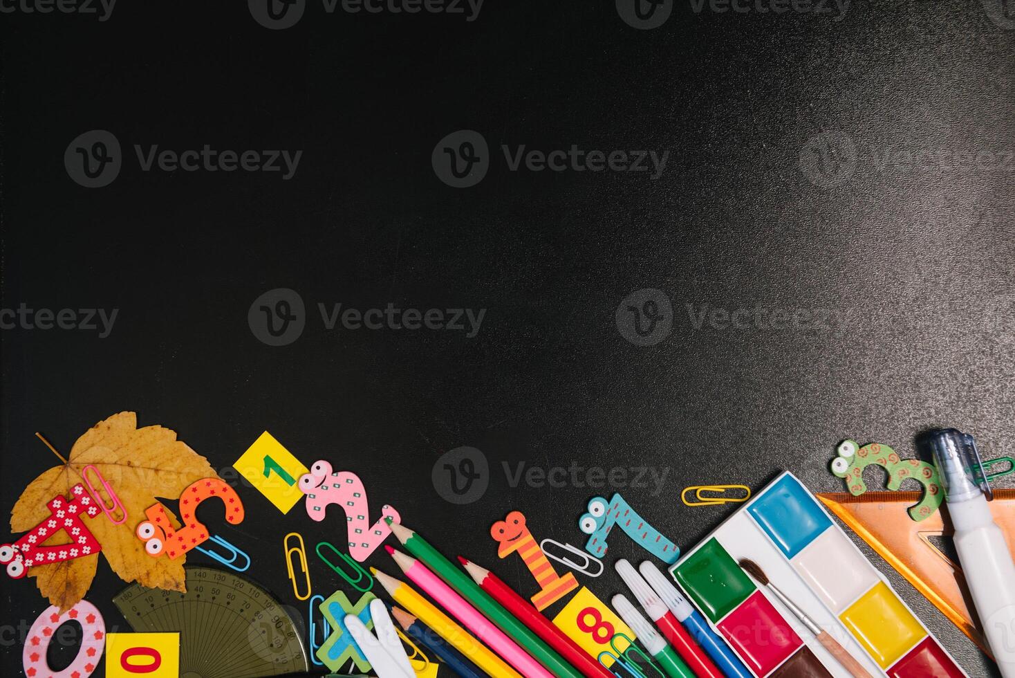 Back to school concept. School and office supplies on blackboard background. Flat lay with copy space photo