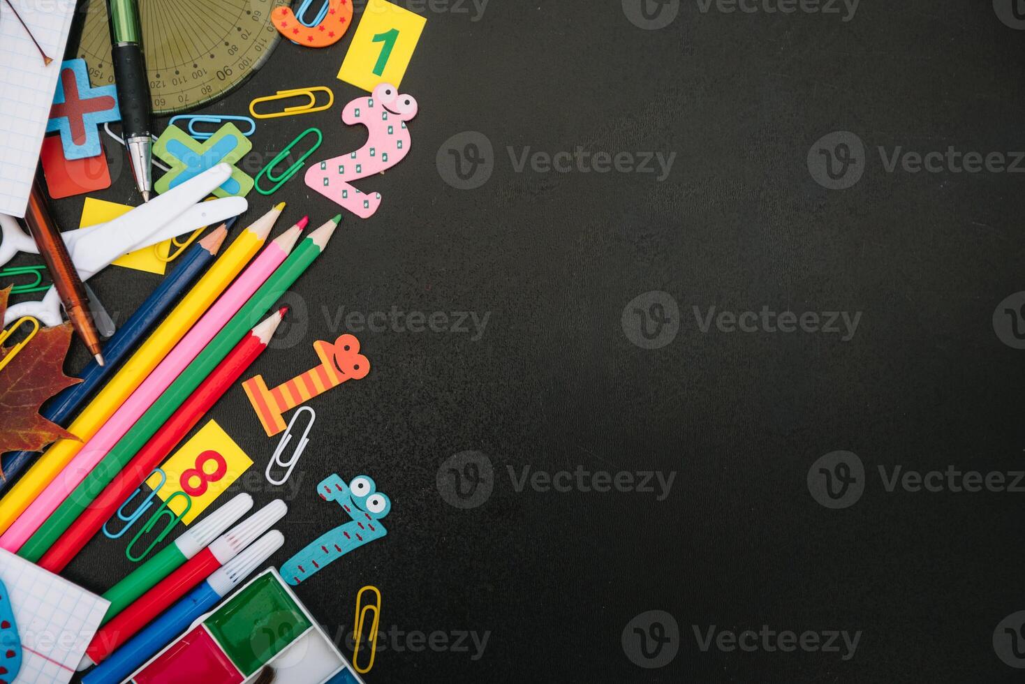Back to school concept. School and office supplies on blackboard background. Flat lay with copy space photo