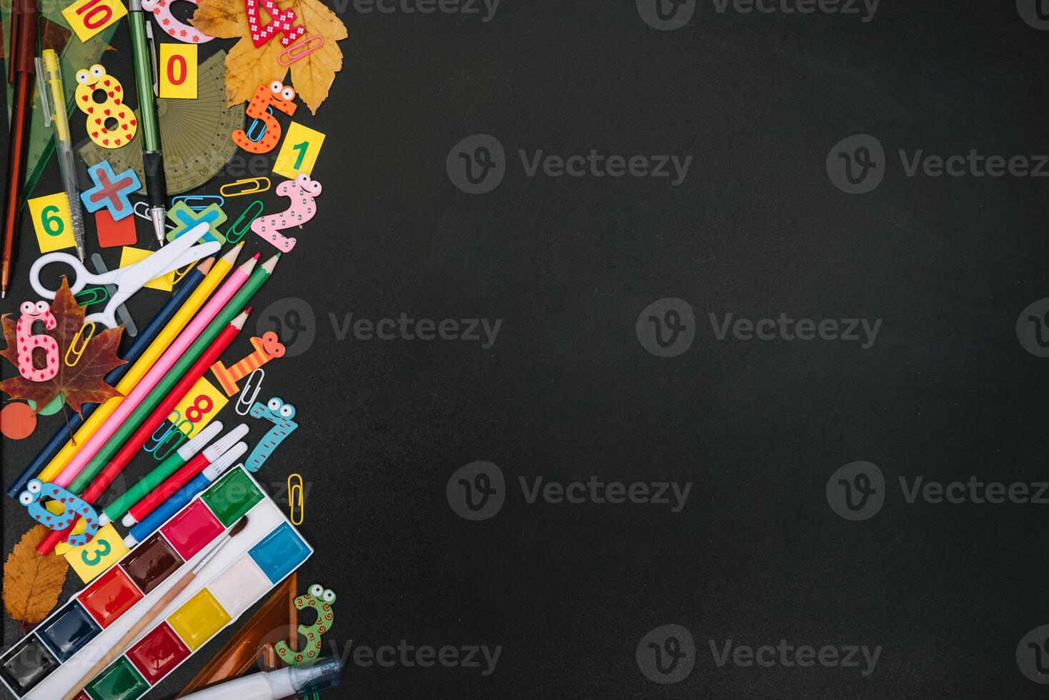 Back to school concept. School and office supplies on blackboard background. Flat lay with copy space photo