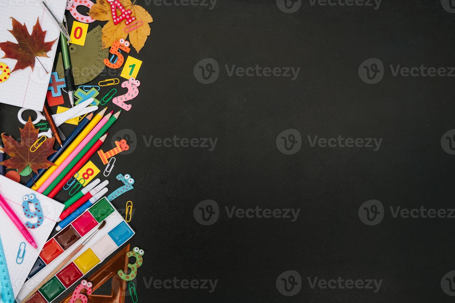 Back to school concept. School and office supplies on blackboard background. Flat lay with copy space photo