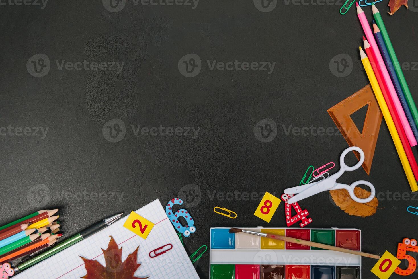 Back to school concept. School and office supplies on blackboard background. Flat lay with copy space photo