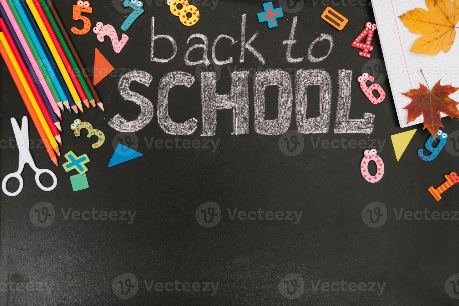 Back to school concept. School and office supplies on blackboard background. Flat lay with copy space photo