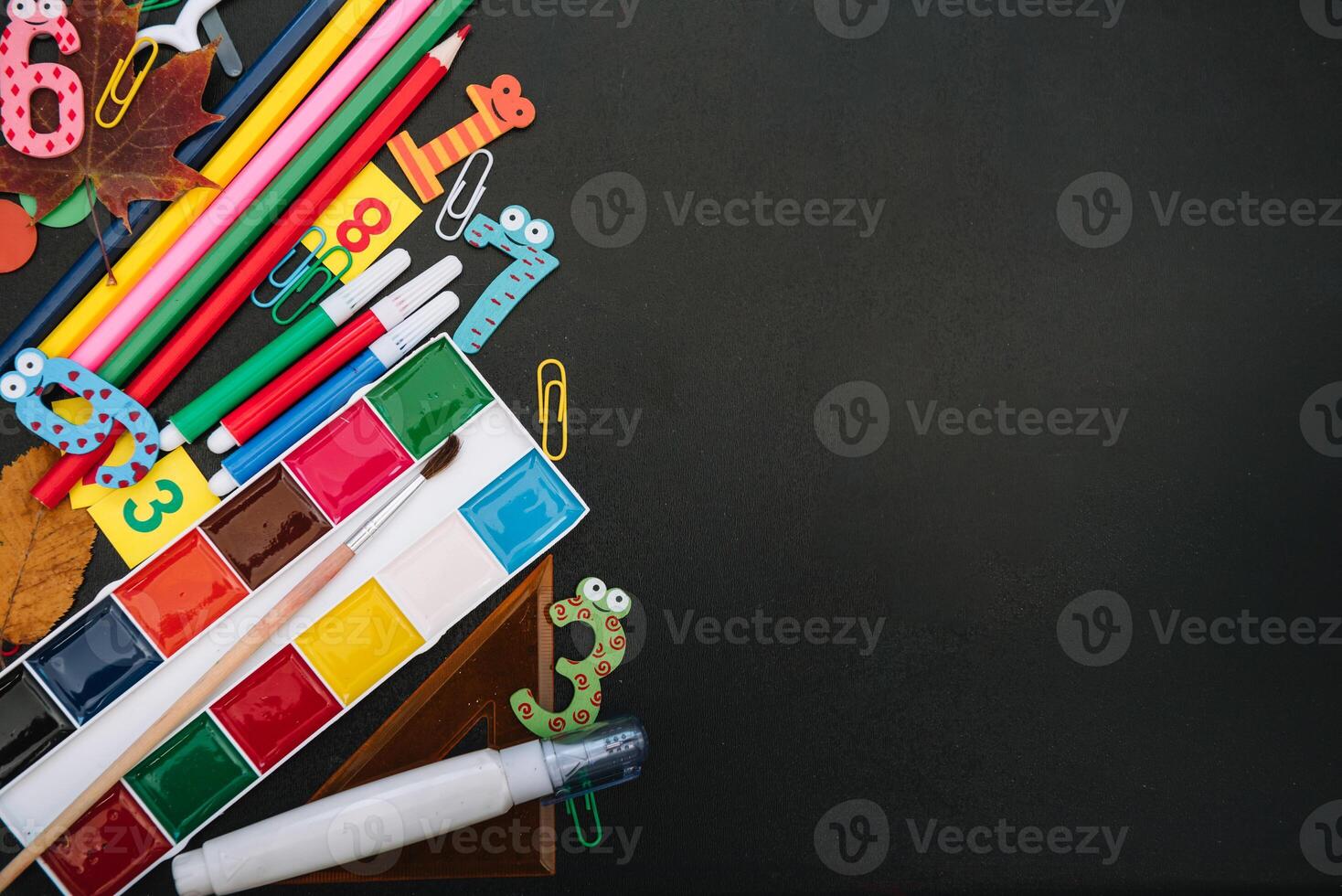 Back to school concept. School and office supplies on blackboard background. Flat lay with copy space. photo
