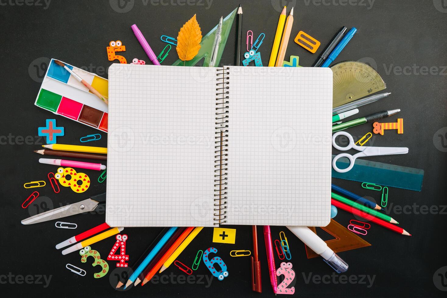 Back to school concept. School and office supplies on blackboard background photo