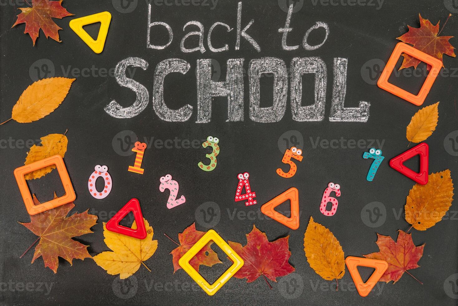 Back to school concept. School and office supplies on blackboard background photo