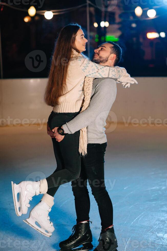 Date lovers in winter rink skates. Concept of Christmas holidays, caring for your loved one. photo