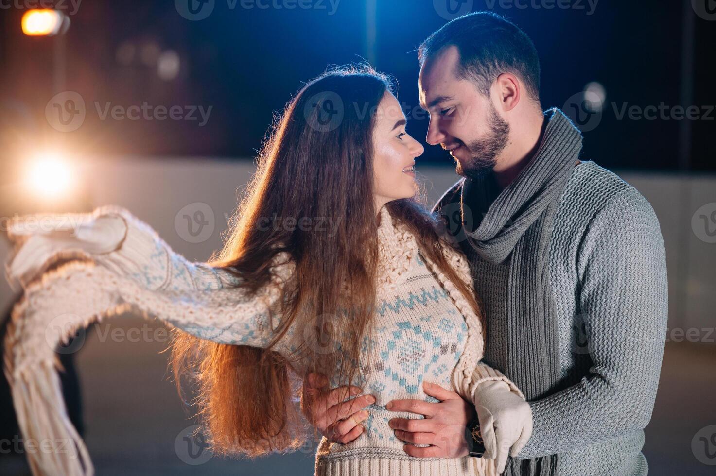 Date lovers in winter rink skates. Concept of Christmas holidays, caring for your loved one. photo