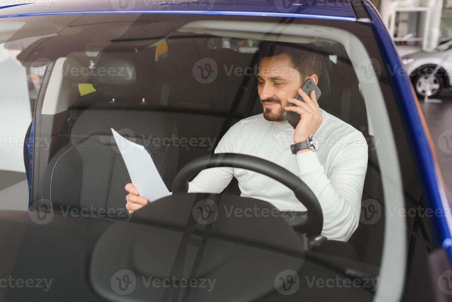 Bearded businessman using cell phone, bearded man in stylish jacket, man in sunglasses, man in luxury car, hairstyle, pretty, attractive, rich, hand watch, jeans, busy, phone work, designer, happy photo