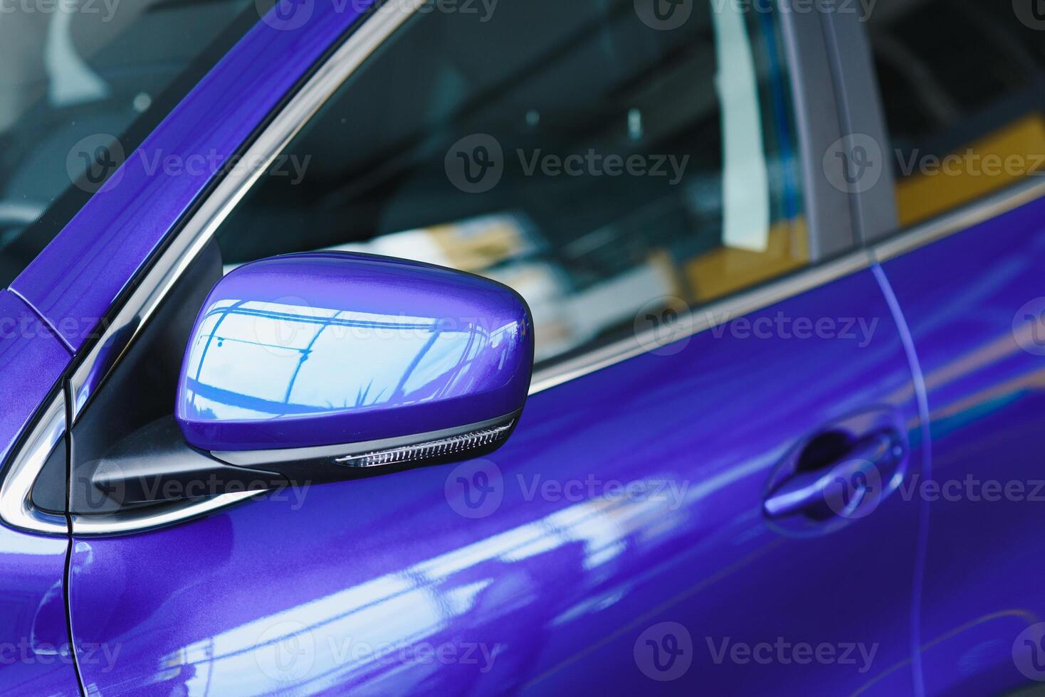 Rear-view mirror closed for safety at car park, Rear-view mirror of gray car , black tinted glass. Close up of wing mirror of gray vehicle. Selective focus. photo