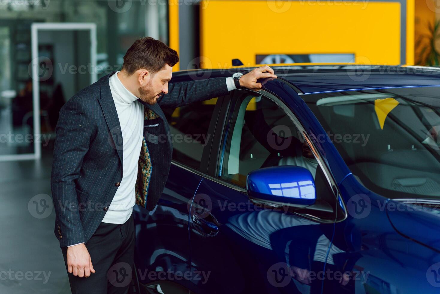 business, car sale, consumerism and people concept - happy man over auto show or salon background photo