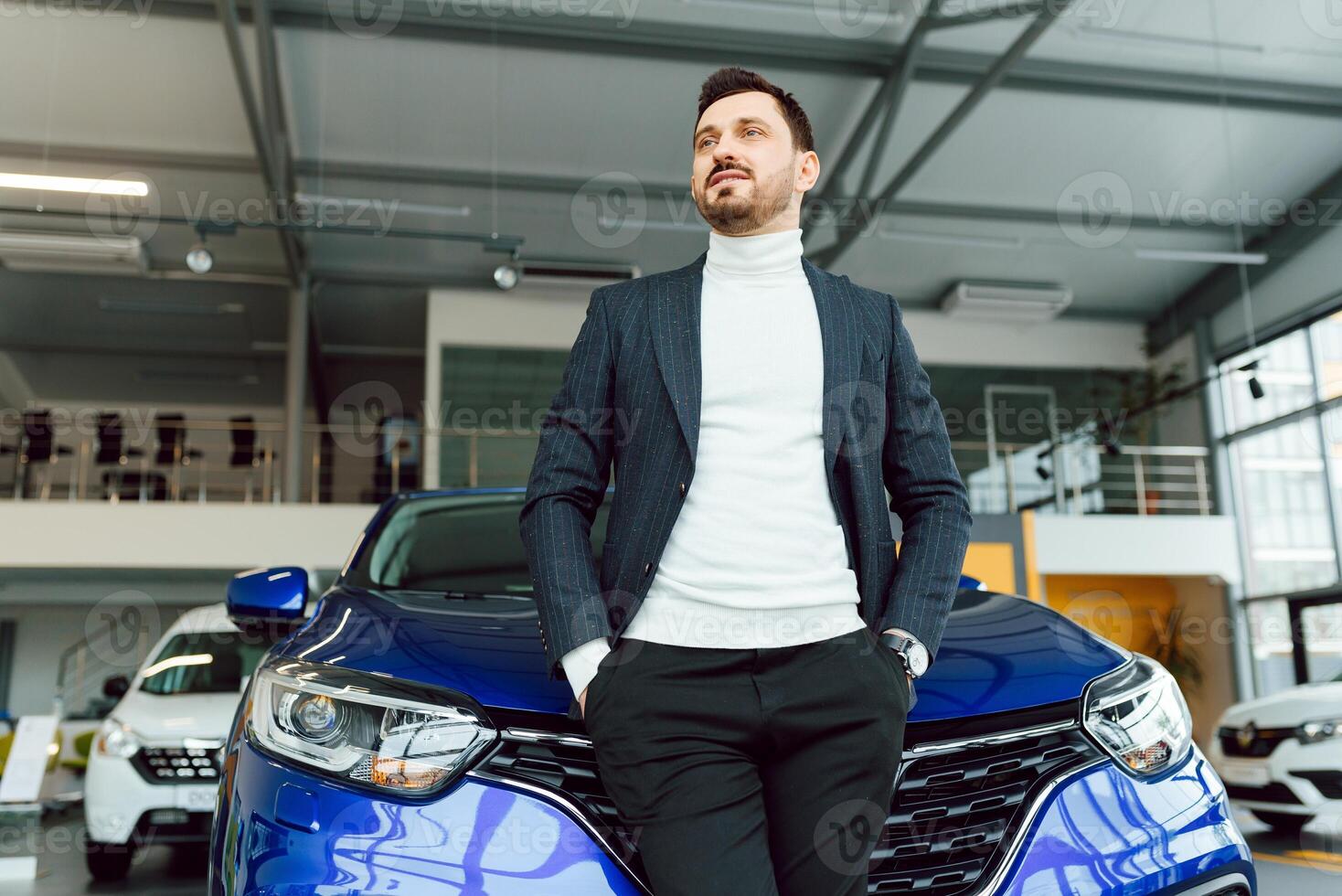 business, car sale, consumerism and people concept - happy man over auto show or salon background photo