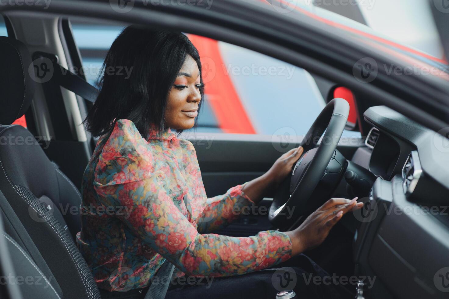 cheerful african female driver inside a car photo