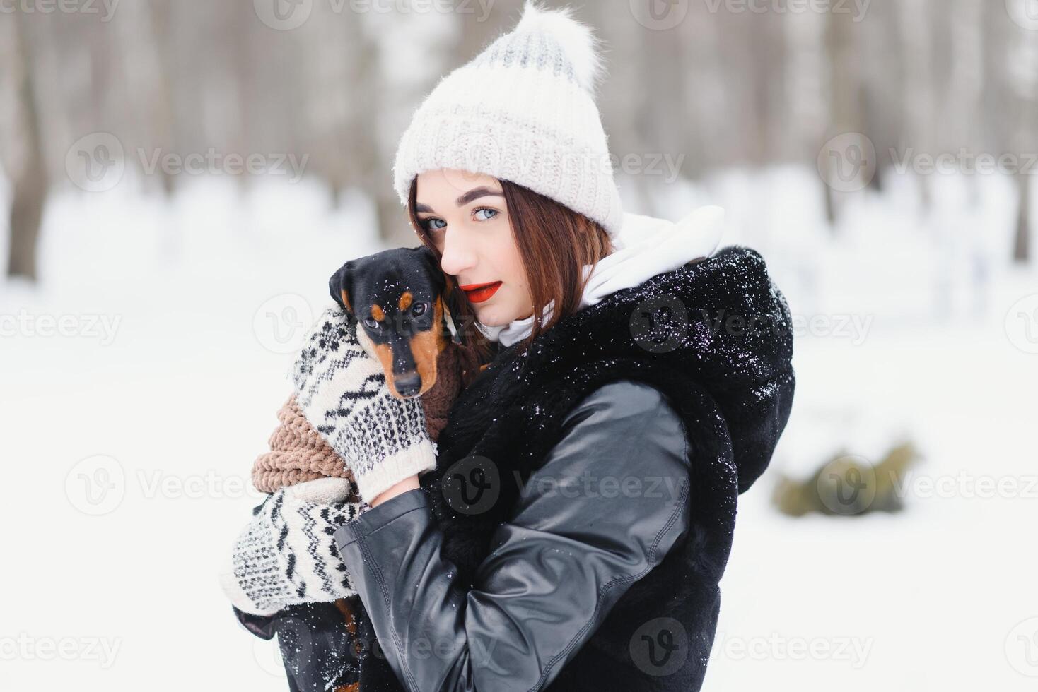 Woman is walking during winter with her dog photo