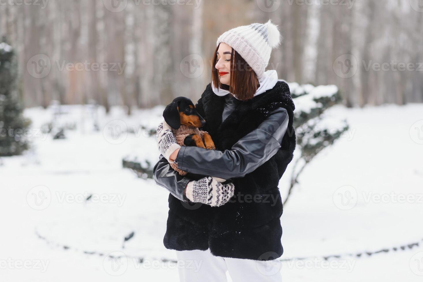 Woman is walking during winter with her dog photo