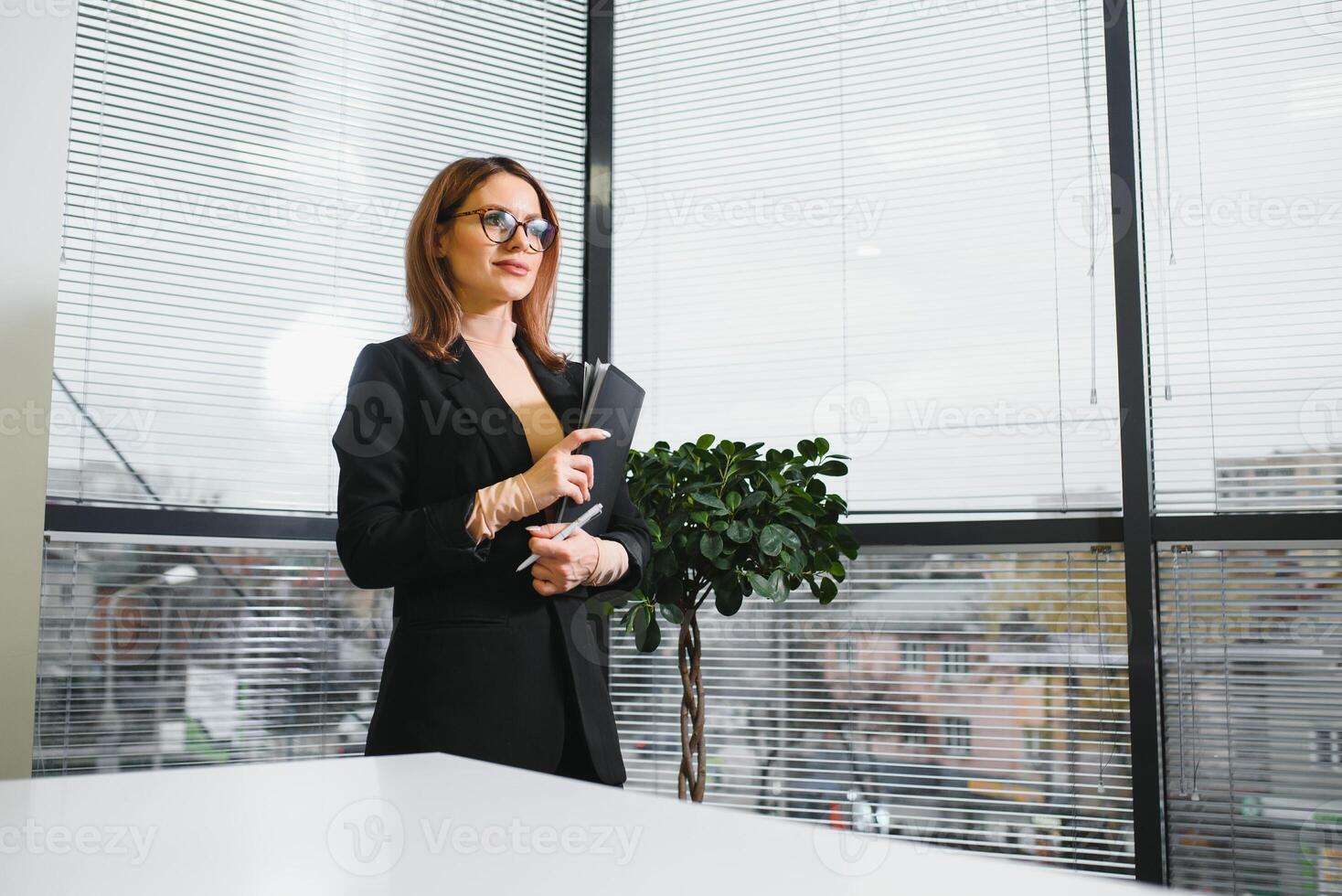 Portrait of smiling modern business woman in office photo