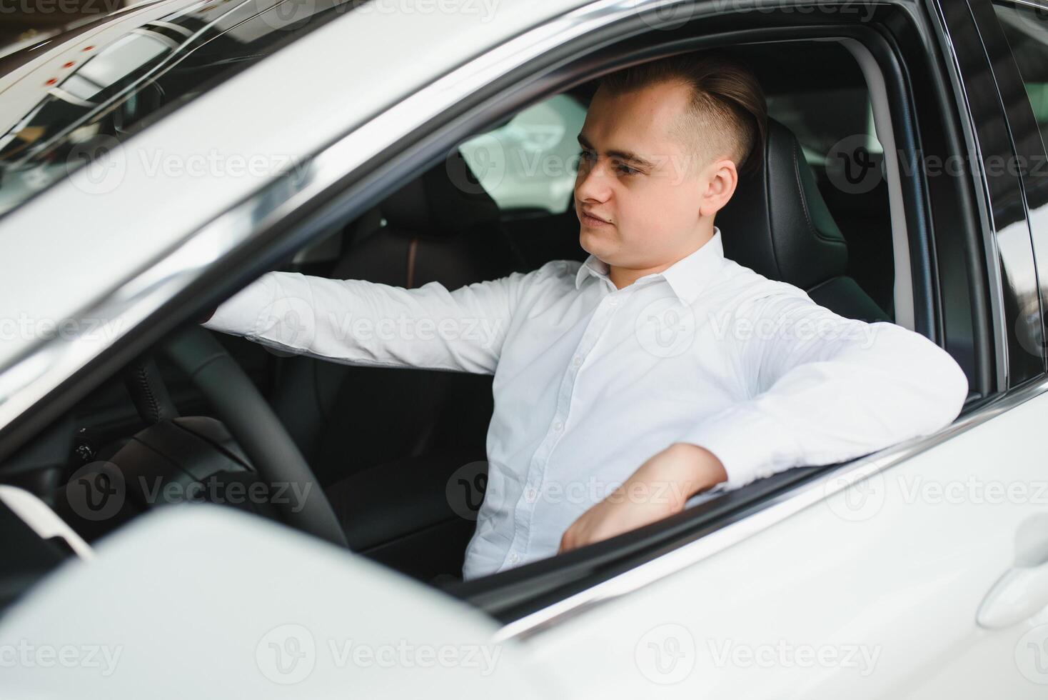 Young man with the keys at the car. photo