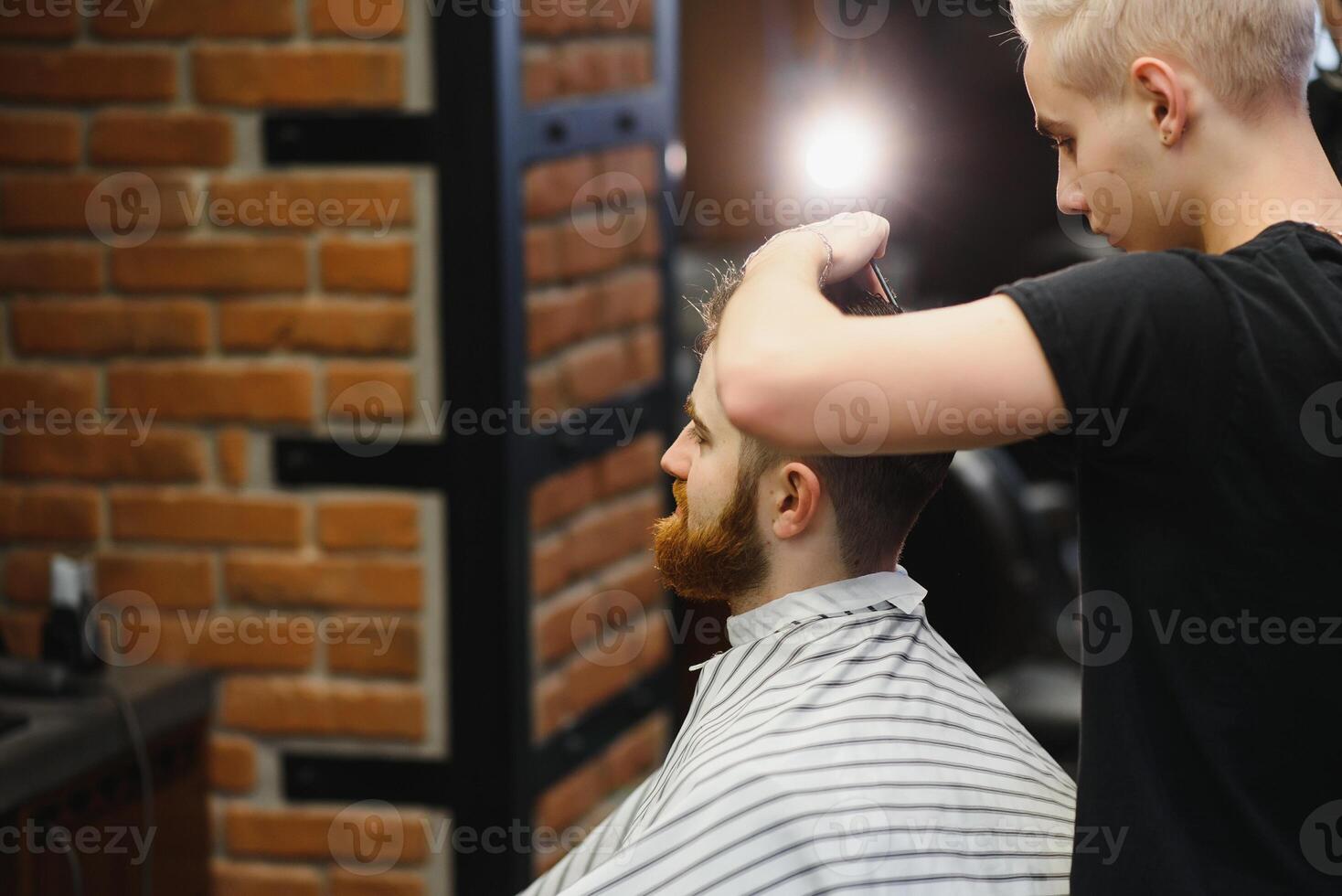 Close-up, master hairdresser does hairstyle and style with scissors and comb. Concept Barbershop photo