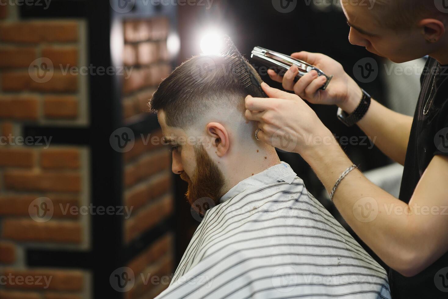 Close-up, master hairdresser does hairstyle and style with scissors and comb. Concept Barbershop photo