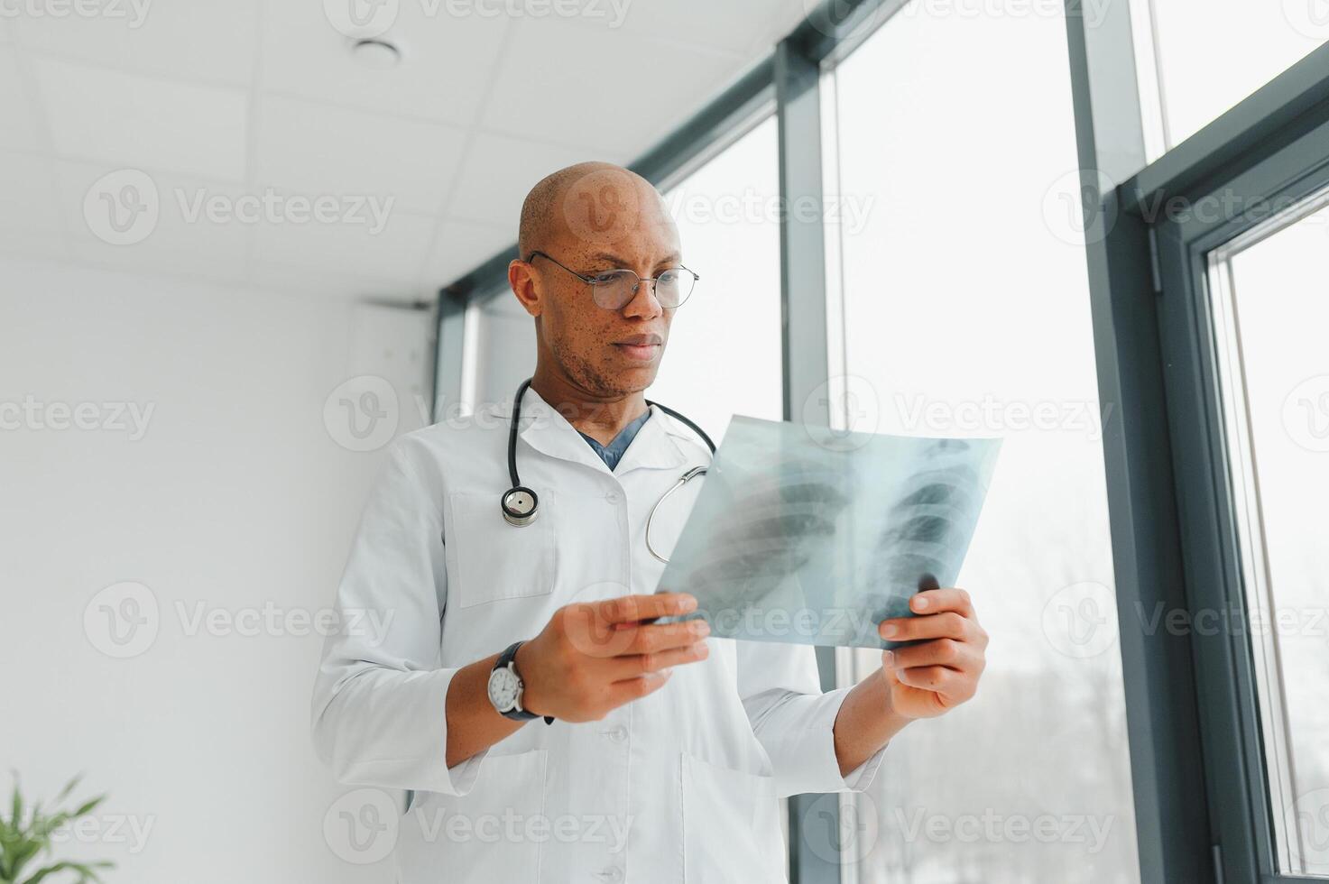 African doctor looking at a radiography. photo