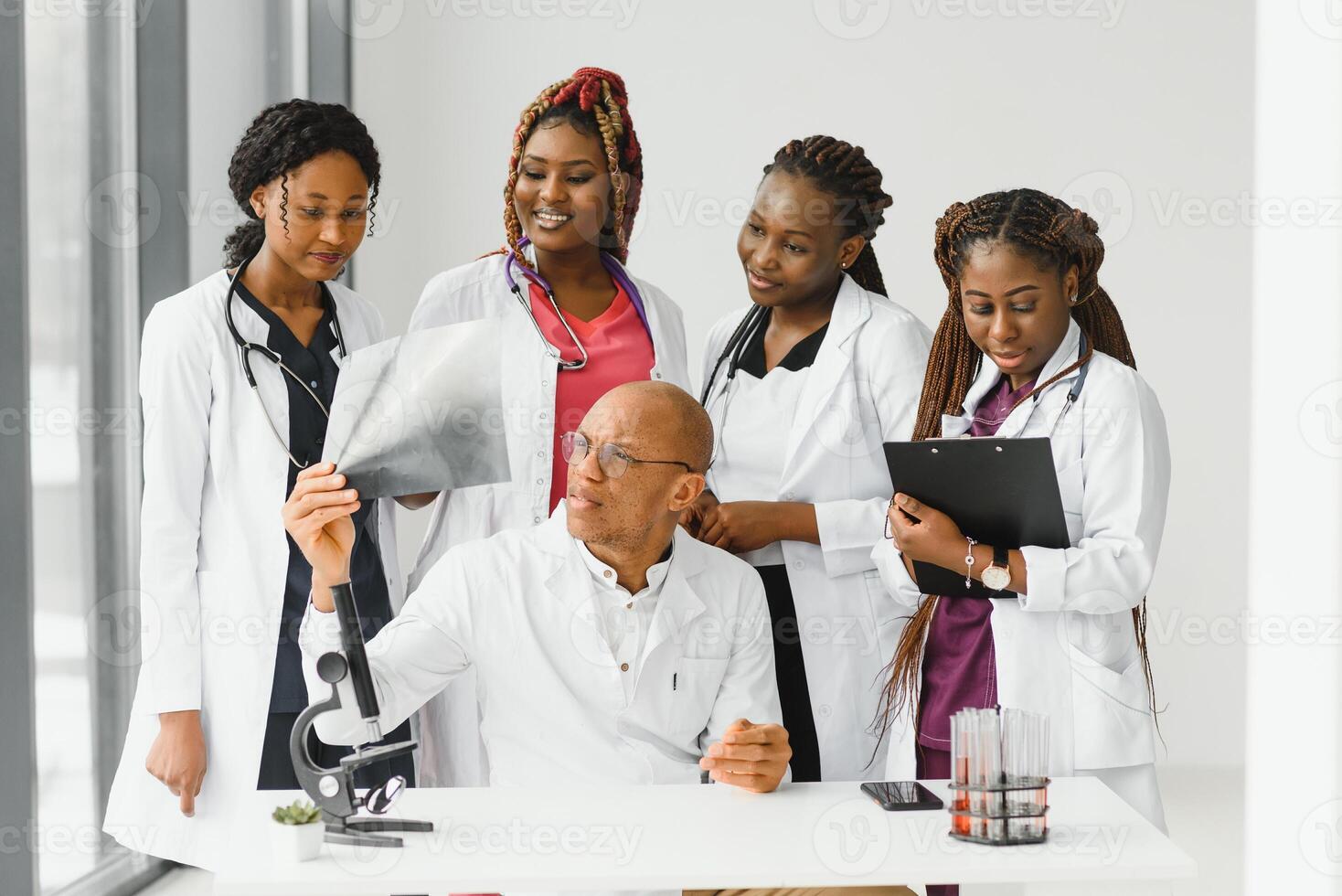 confident african medical doctor and colleagues portrait in hospital. photo