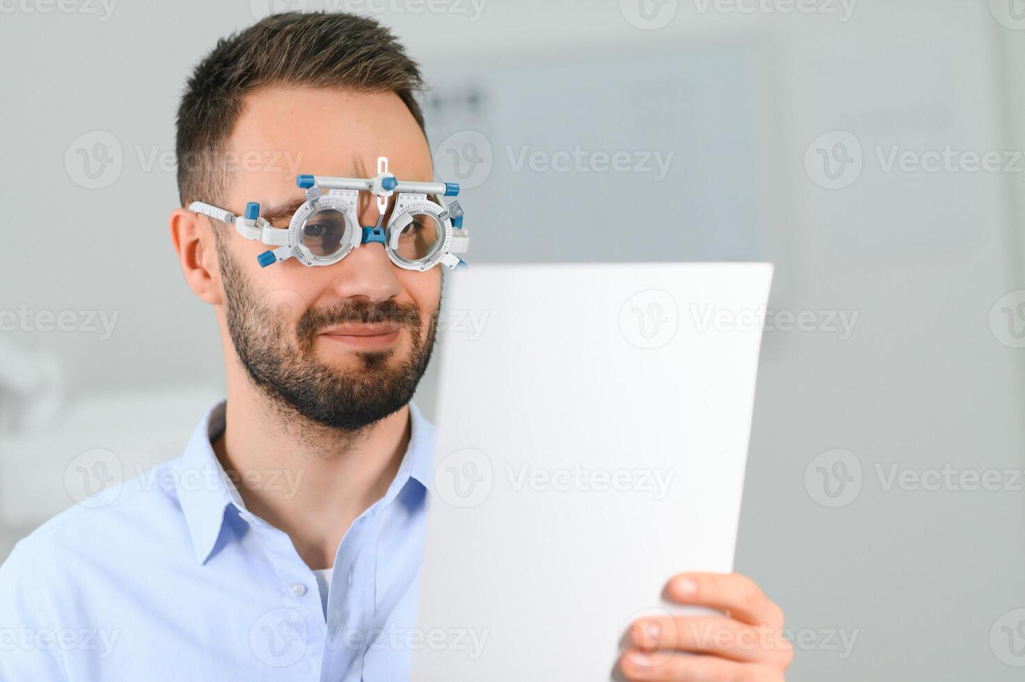 Ophthalmology concept. Male patient under eye vision examination in eyesight ophthalmological correction clinic photo