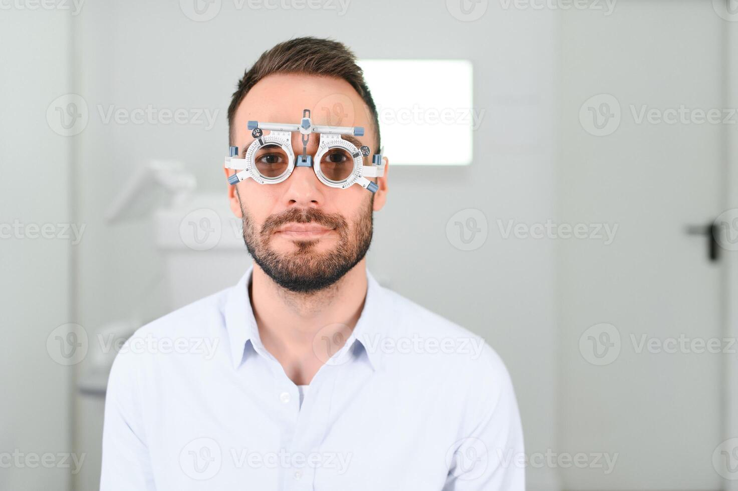Ophthalmology concept. Male patient under eye vision examination in eyesight ophthalmological correction clinic photo