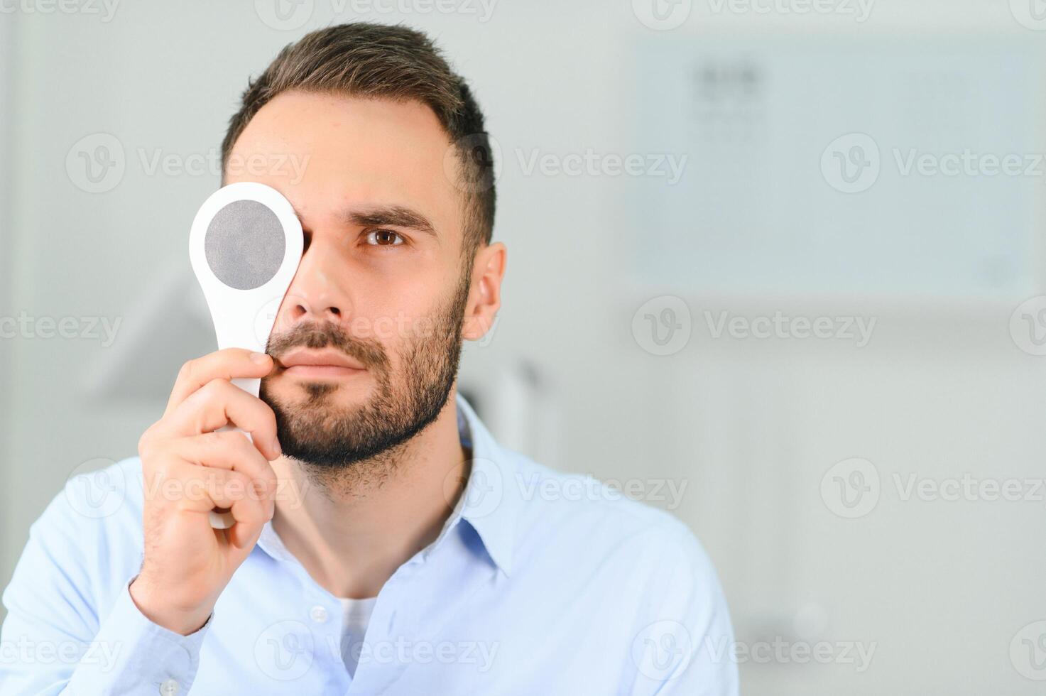 Test of sight. Man is checking his vision indoors in the clinic photo