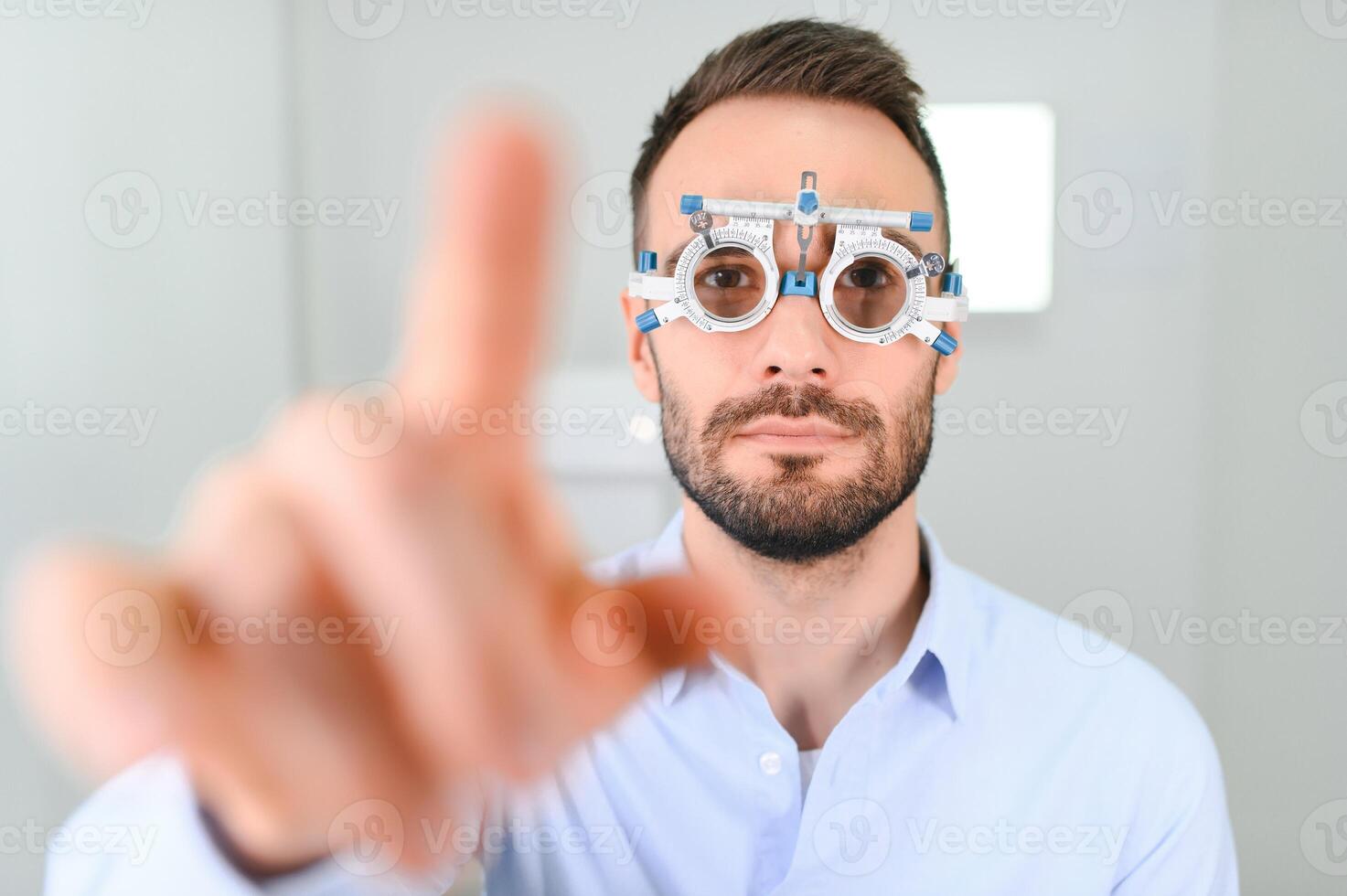 Ophthalmology concept. Male patient under eye vision examination in eyesight ophthalmological correction clinic photo