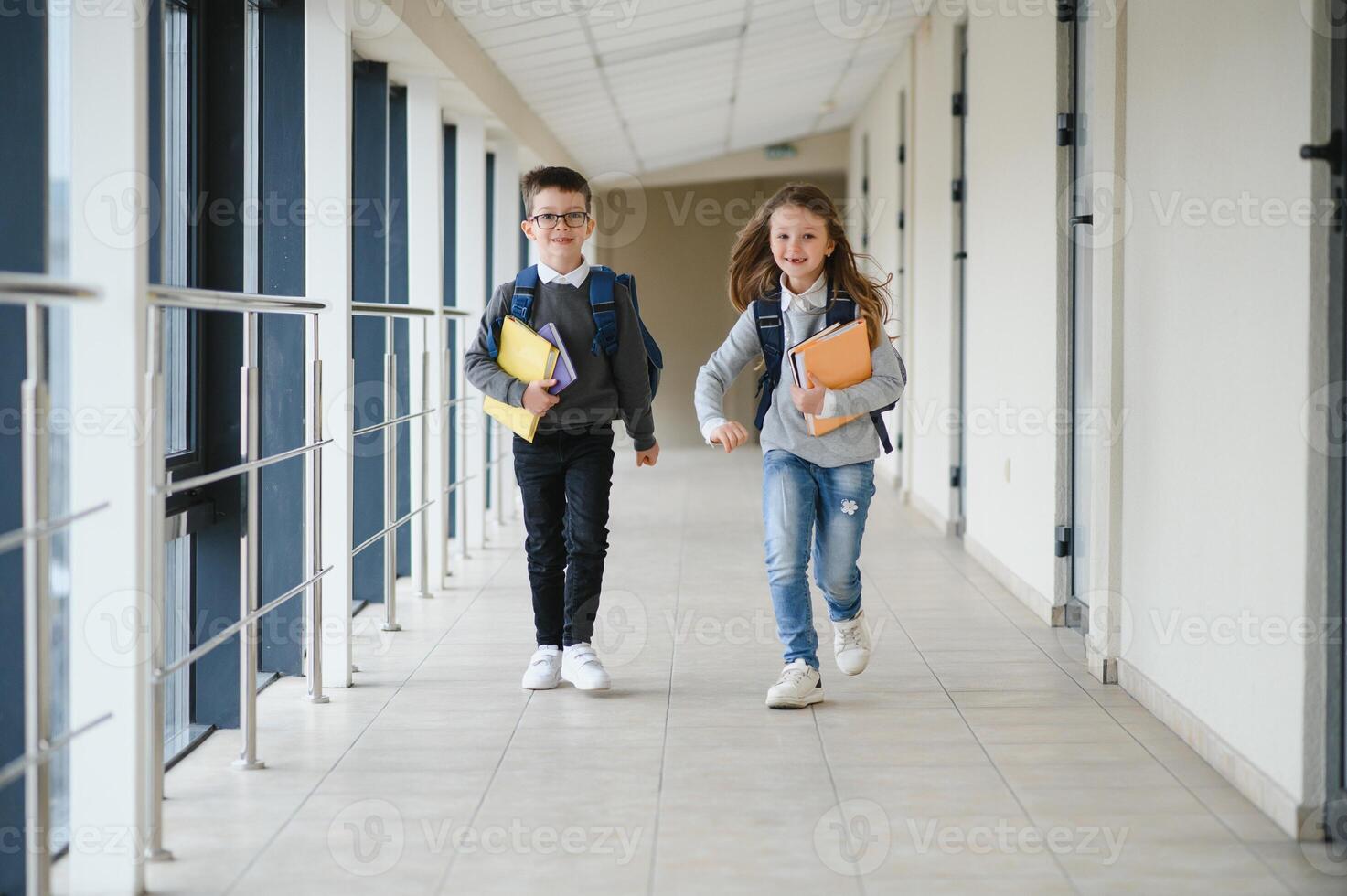 Schoolboy with schoolbag and books in the school. Education concept. Back to school. Schoolkid going to class. Stylish boy with backpack. Boy ready to study photo