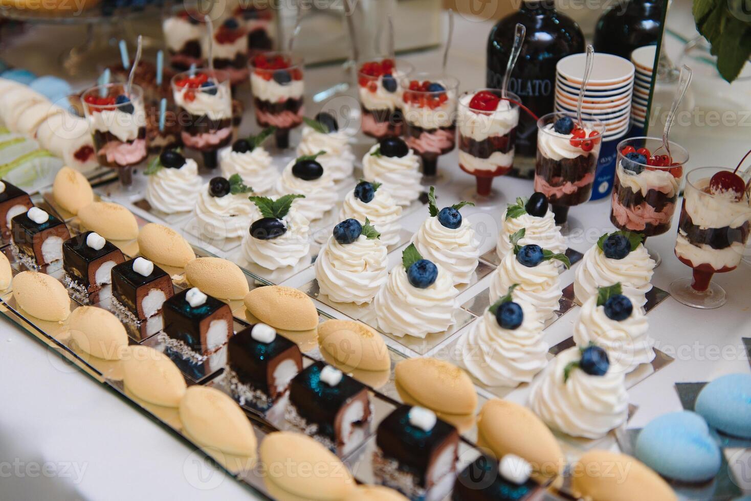 various dessert with fresh fruit on buffet line, sweet. photo