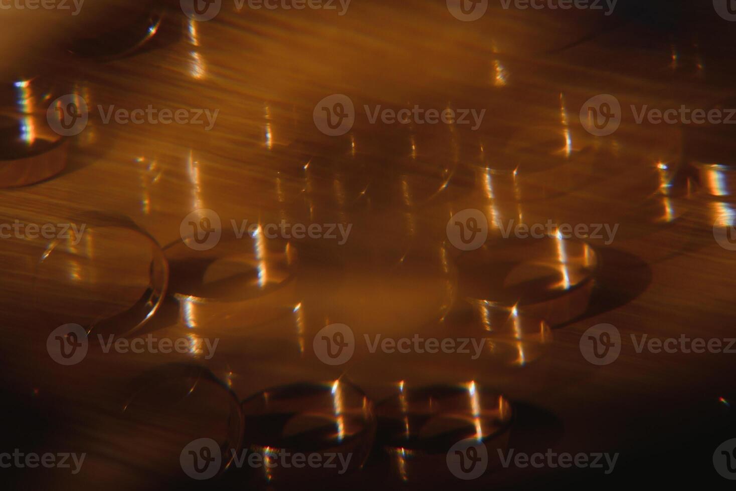 Elegant wedding rings for the bride and groom on a black background with highlights, macro, selective focus. photo