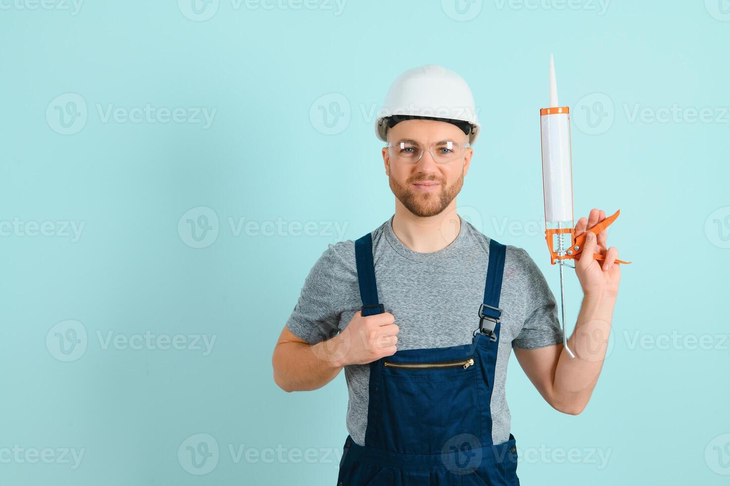 Portrait of smiling worker in uniform isolated on blue background photo