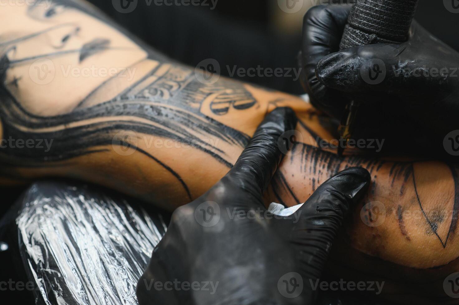 Professional tattoo artist working in his tattoo studio. photo