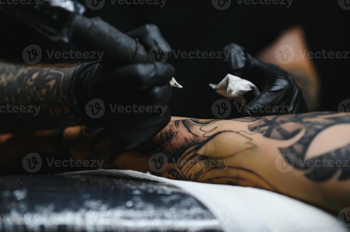 Professional tattoo artist working in his tattoo studio. photo