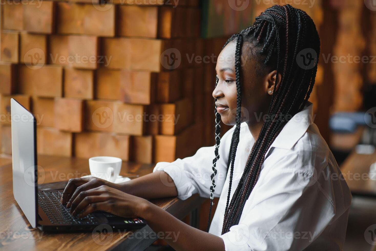 Lucky day. Emotional black woman looking at laptop, clenching fists and screaming, working at cafe, copy space photo