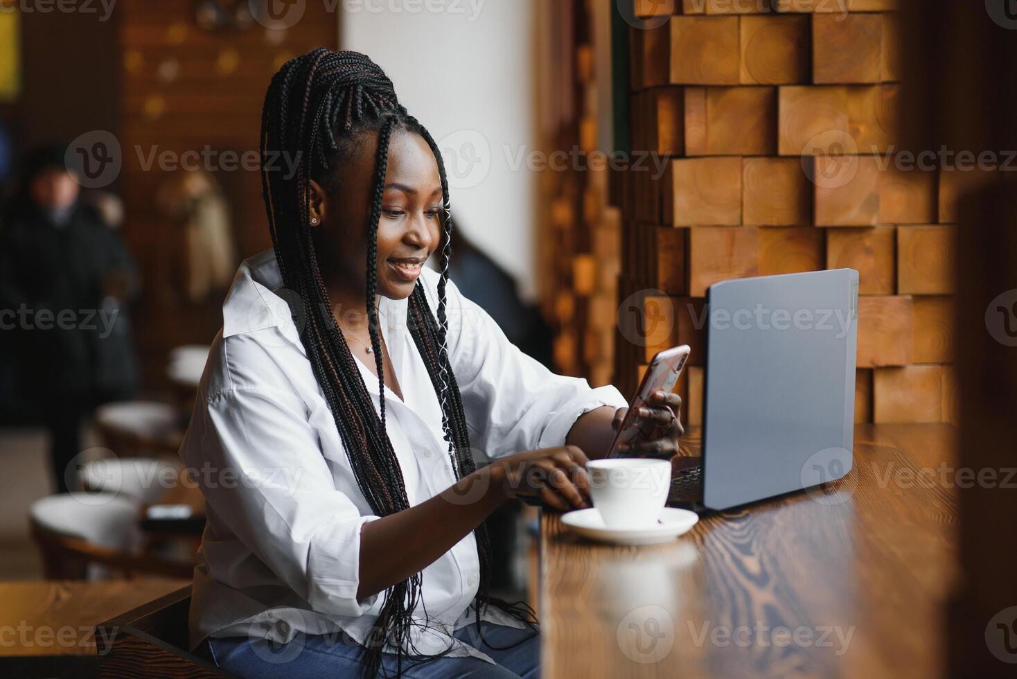 Happy african american woman worker using laptop work study at computer in loft office or cafe, smiling mixed race female student freelancer using pc app dating communicating online watching webinar photo