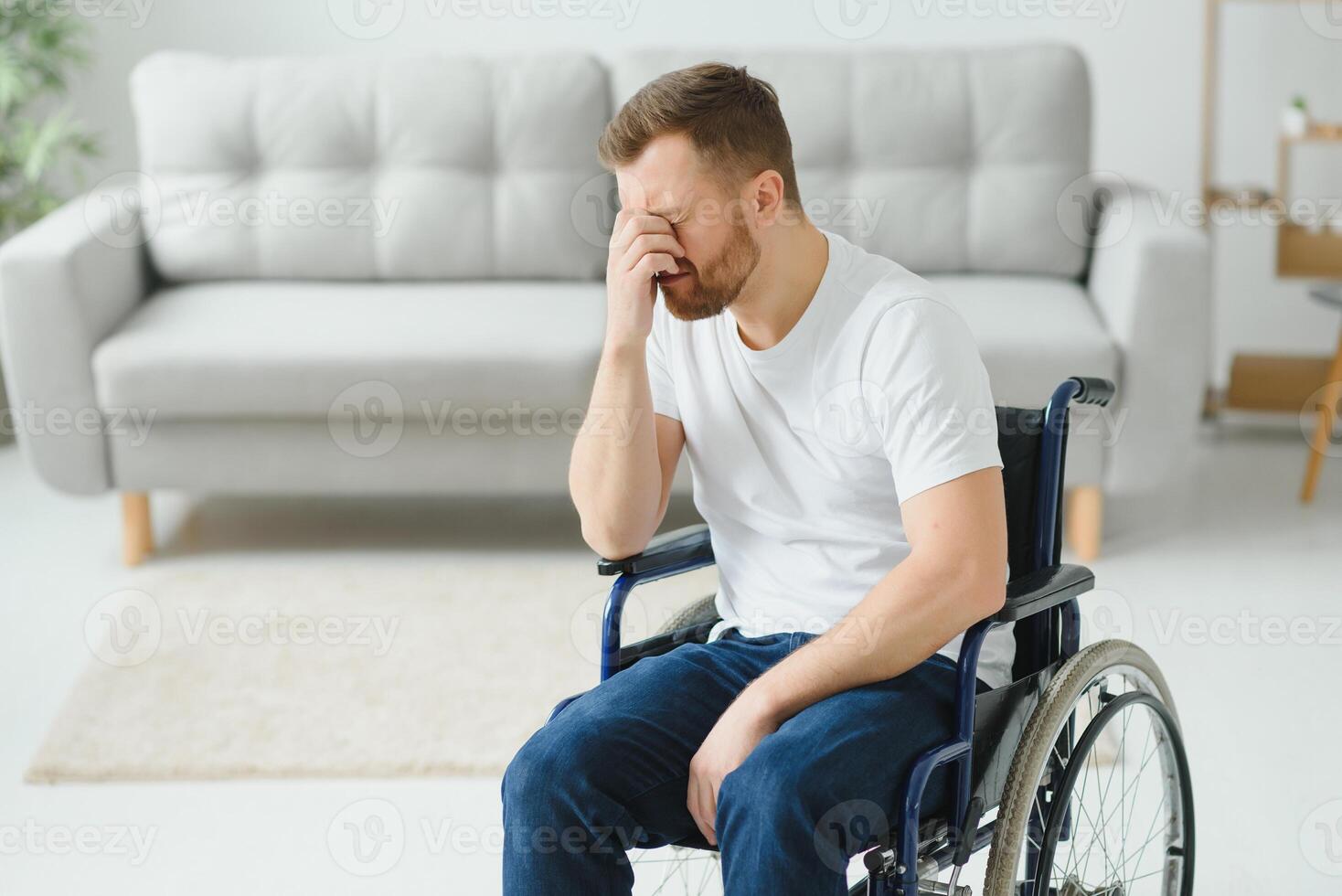 Disabled young man suffering at home photo