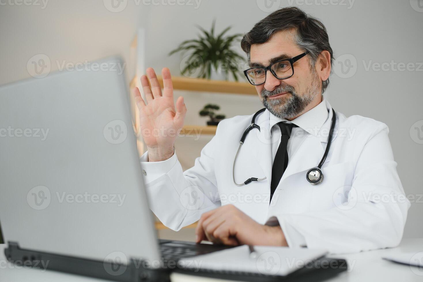 Doctor consulting patient using chat in clinic, view from web camera. photo