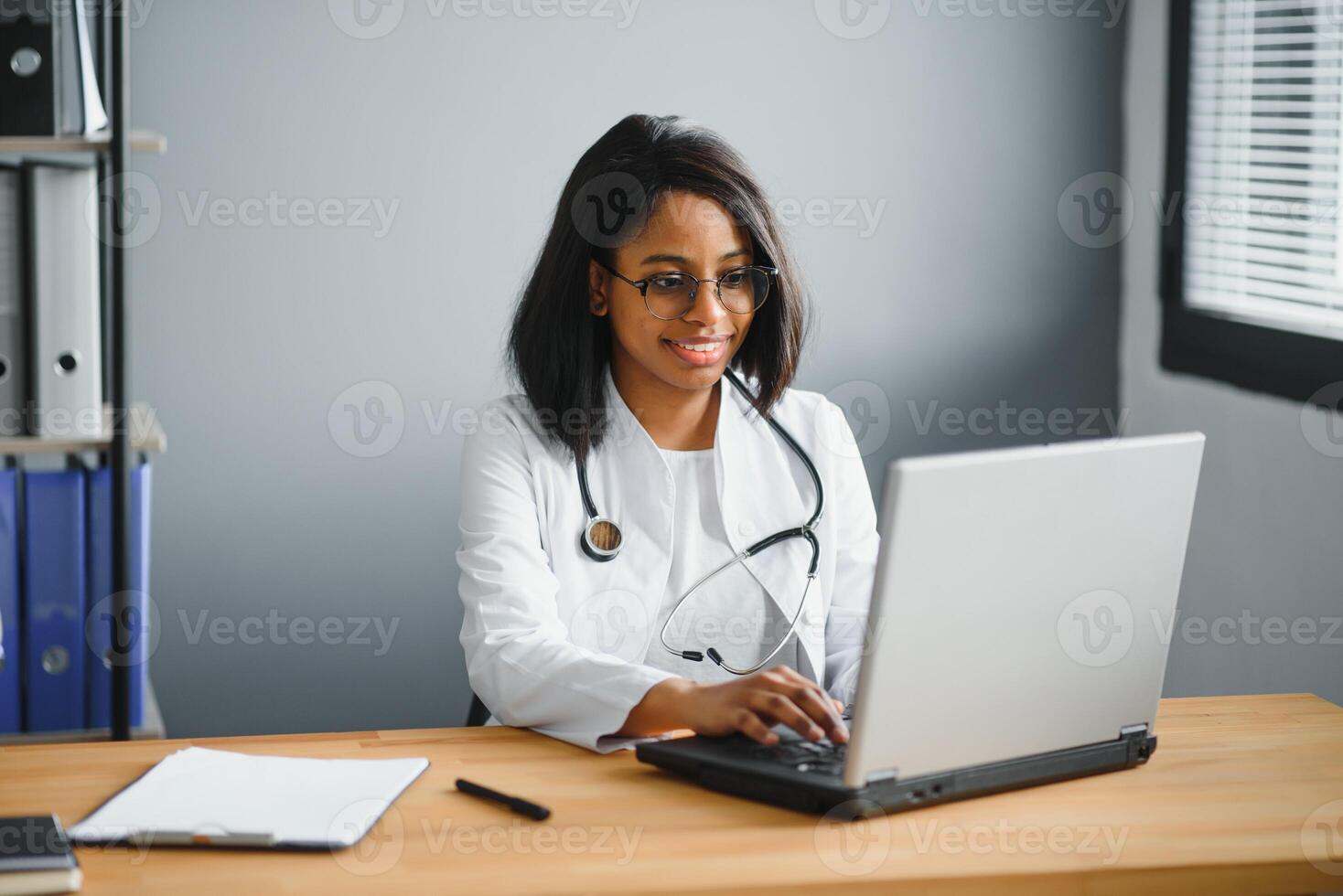 African female doctor make online telemedicine call consult patient. Afro american black woman therapist talking to camera in remote conference chat. Webcam view, face headshot. photo