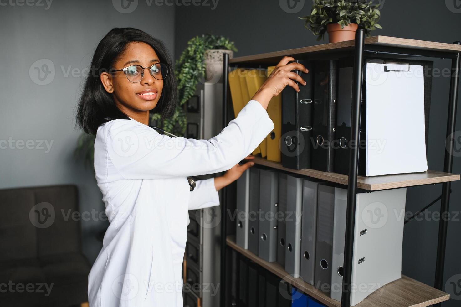Portrait Of Female Doctor Wearing White Coat In Office. photo