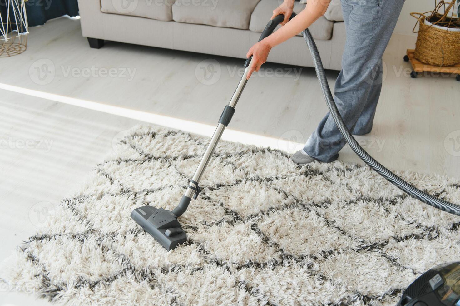 Cleaning concept. woman cleaning carpet with vacuum cleaner. photo