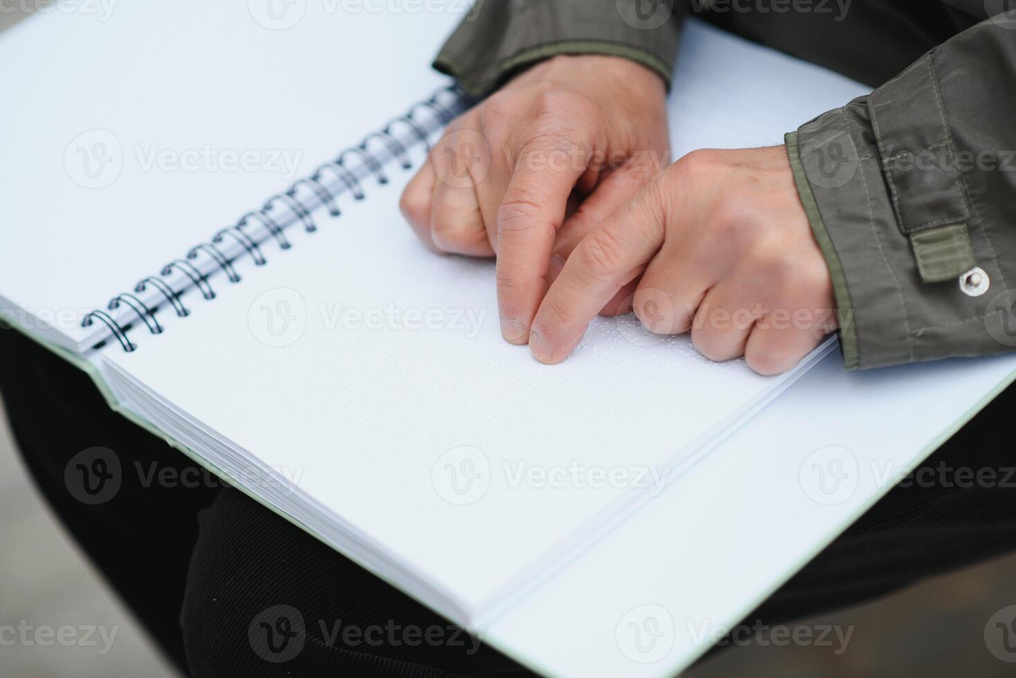 Old woman' s hands, reading a book with braille language. photo