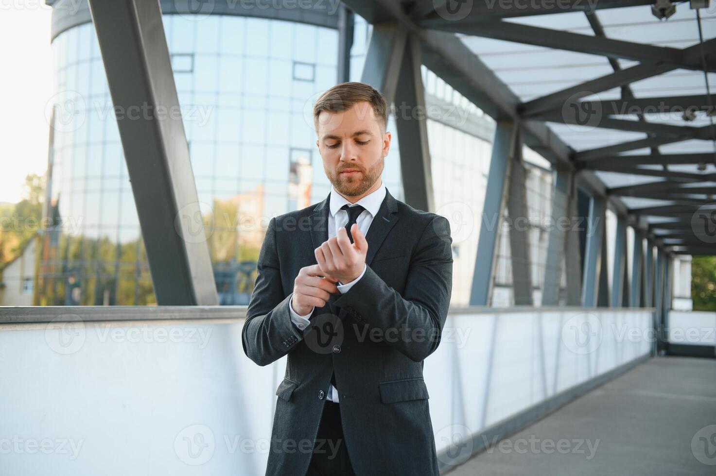 Handsome male model posing wearing a back suit. photo