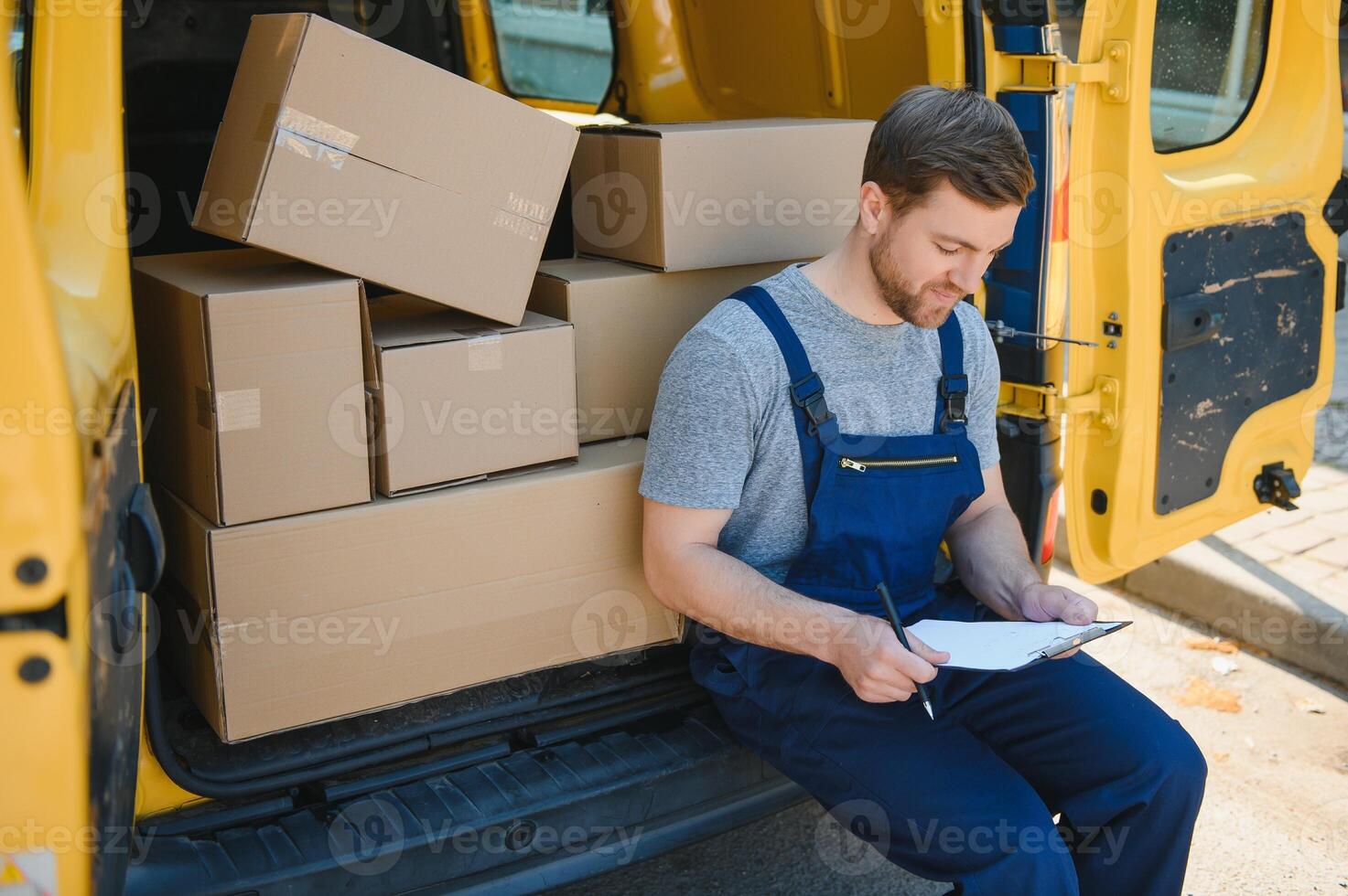 Courier service for the delivery of goods. Express service a man in a uniform delivers boxes. The employee carries the order home to the client. photo