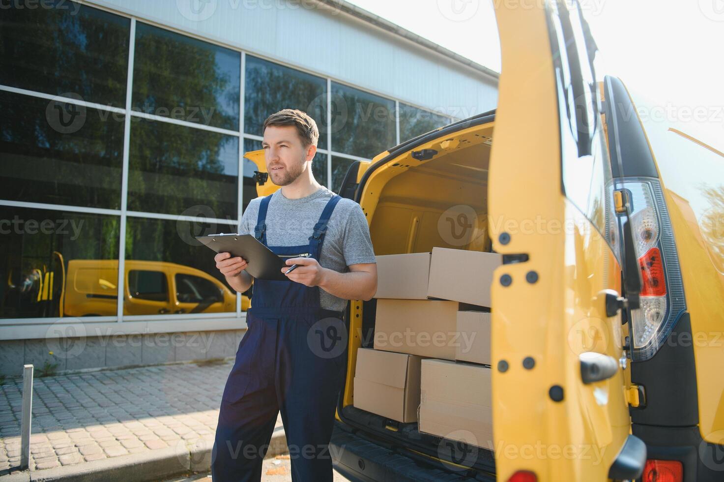 young delivery man courier in uniform hold documents clipboard checking list parcel post boxes near a car for service shipment to customer, Online shopping service concepts. photo