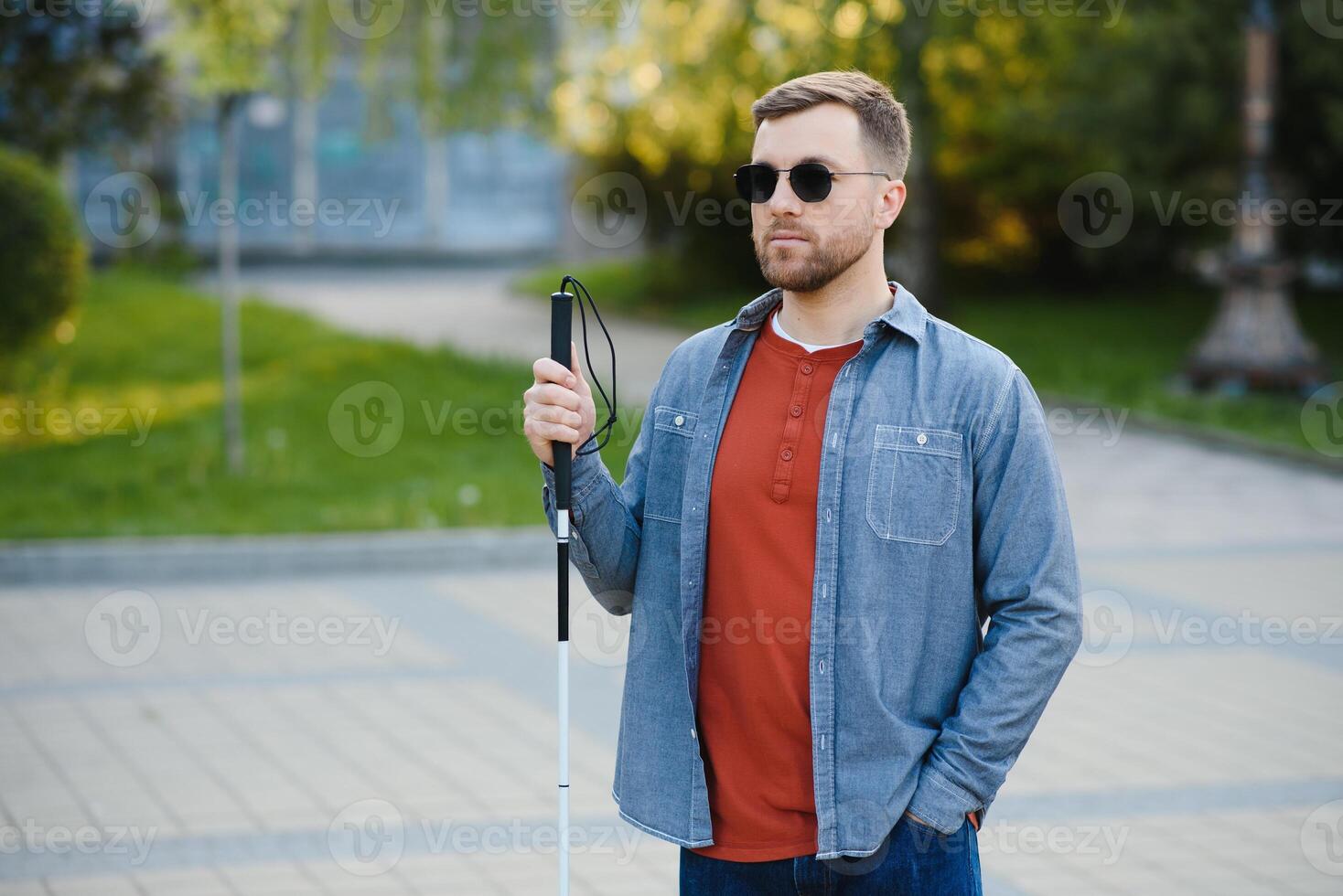 Blind man. People with disability, handicapped person and everyday life. Visually impaired man with walking stick. photo